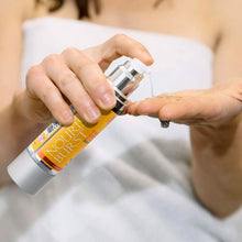 Load image into Gallery viewer, Woman pumping Nourish Burst Hair Growth Accelerating Serum with Biotin, Argan Oil, Keratin and Redensyl onto fingertips to show gel like appearance