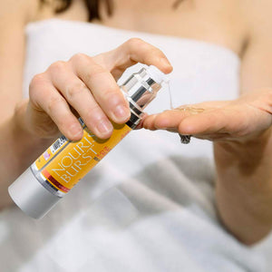 Woman pumping Nourish Burst Hair Growth Accelerating Serum with Biotin, Argan Oil, Keratin and Redensyl onto fingertips to show gel like appearance