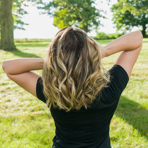 Female model using 100% Natural Hair Growth Support Conditioner