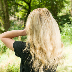 Woman showing her Beautiful Thick Blonde hair with wave on the bottom