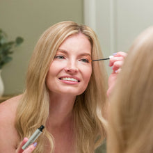 Load image into Gallery viewer, Woman using thin applicator to apply eyelash renewal serum to upper eyelid