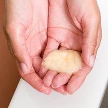 Load image into Gallery viewer, Woman holding a dollop of Organic Lavender Sugar Body Scrub with Coconut in her hands 