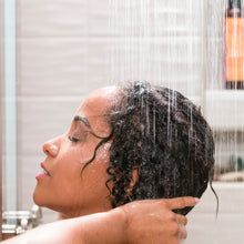 Load image into Gallery viewer, African American woman washing her hair in the shower